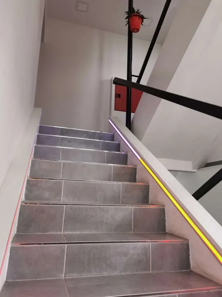 Staircase lit with pixel LED strips hidden in aluminium profiles