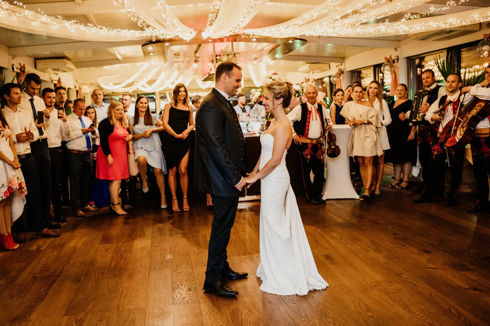 First dance at a wedding with festoon lights dimmed over DMX