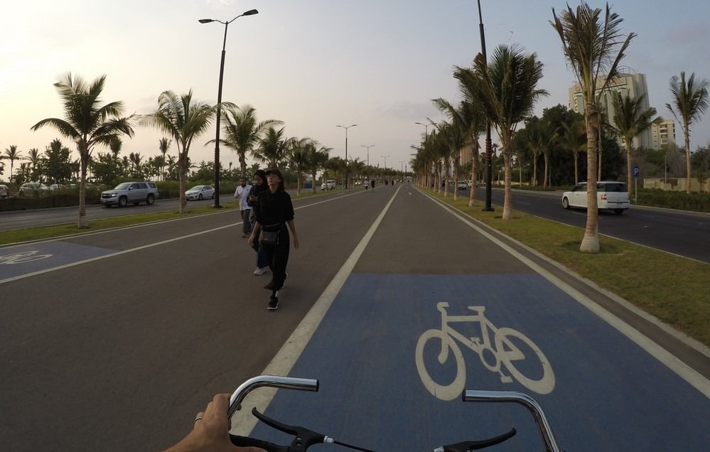 A wide bike path with much space for both lines of traffic and pedestrians in a alley of palm trees. We used this frequently during preparation of 88th National Day in Jeddah, Saudi Arabia.